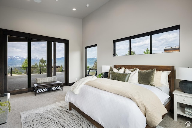 942 N Explorer Peak Dr Unit 420, Heber City, UT 84032 - carpeted bedroom featuring a towering ceiling, multiple windows, recessed lighting, a mountain view, and access to exterior
