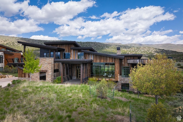 942 N Explorer Peak Dr Unit 420, Heber City, UT 84032 - back of house featuring a mountain view, a chimney, and stone siding