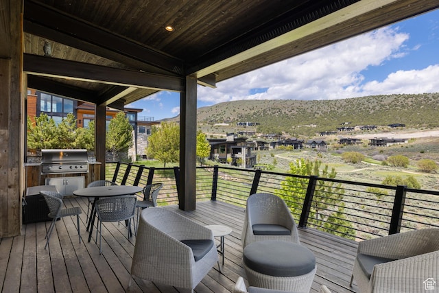 942 N Explorer Peak Dr Unit 420, Heber City, UT 84032 - wooden deck featuring area for grilling, a mountain view, and outdoor dining space