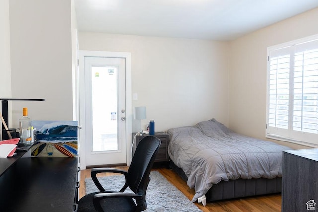 1444 S Beacon Dr E, Salt Lake City, UT 84108 - bedroom featuring multiple windows, wood finished floors, and a desk