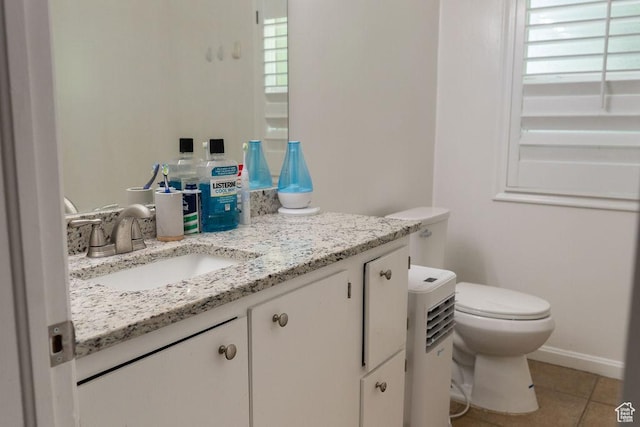 1444 S Beacon Dr E, Salt Lake City, UT 84108 - half bathroom with toilet, vanity, healthy amount of natural light, and tile patterned floors
