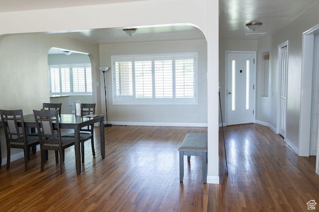 1444 S Beacon Dr E, Salt Lake City, UT 84108 - dining area with healthy amount of natural light, dark wood-style floors, baseboards, and arched walkways