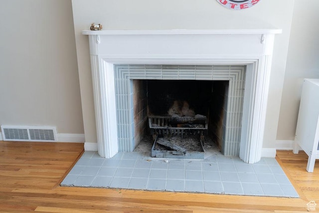 1444 S Beacon Dr E, Salt Lake City, UT 84108 - detailed view of wood finished floors, baseboards, and a tile fireplace