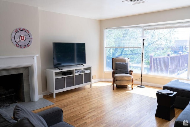 1444 S Beacon Dr E, Salt Lake City, UT 84108 - living room with light wood-style floors, baseboards, and a fireplace