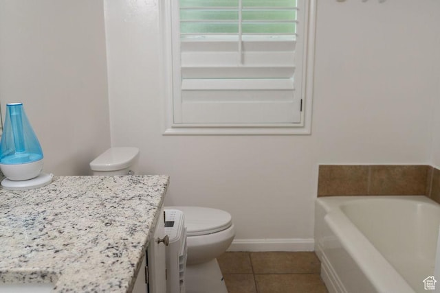 1444 S Beacon Dr E, Salt Lake City, UT 84108 - full bathroom with vanity, a garden tub, tile patterned floors, toilet, and baseboards