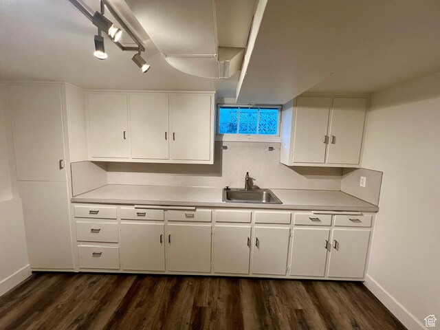 144 S 100 W, Tremonton, UT 84337 - kitchen featuring a sink, light countertops, baseboards, and white cabinetry