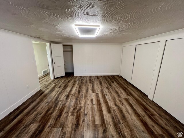 144 S 100 W, Tremonton, UT 84337 - unfurnished bedroom with dark wood-style floors, two closets, and baseboards
