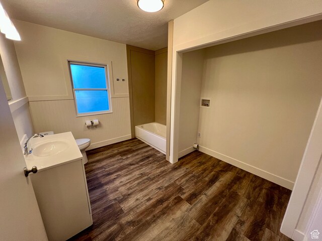 144 S 100 W, Tremonton, UT 84337 - full bath with toilet, vanity, wood finished floors, a tub to relax in, and baseboards