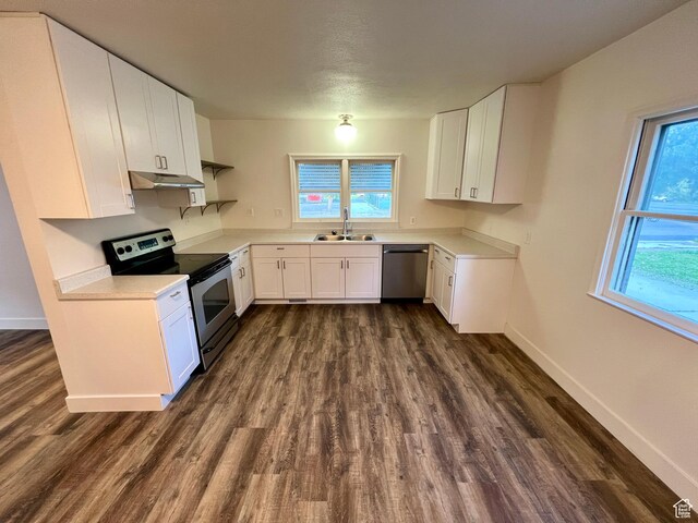 144 S 100 W, Tremonton, UT 84337 - kitchen with stainless steel appliances, a sink, dark wood-style floors, light countertops, and under cabinet range hood