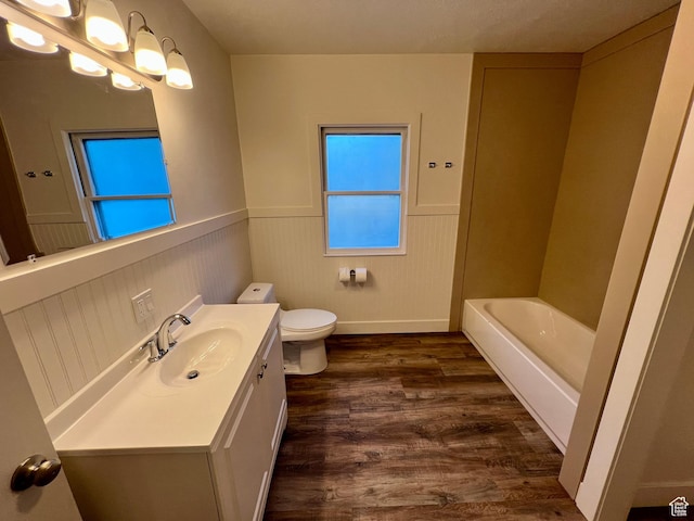 144 S 100 W, Tremonton, UT 84337 - full bath with vanity, a wainscoted wall, toilet, wood finished floors, and a tub