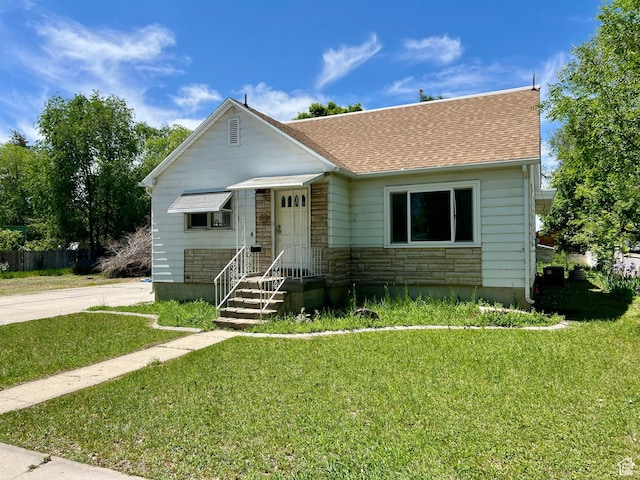 144 S 100 W, Tremonton, UT 84337 - bungalow featuring stone siding, a front lawn, and roof with shingles