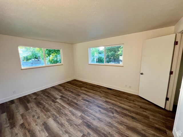144 S 100 W, Tremonton, UT 84337 - spare room featuring dark wood-type flooring and baseboards
