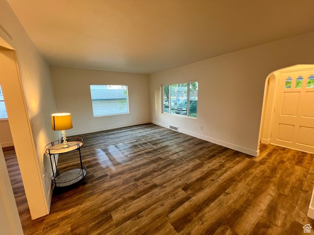 144 S 100 W, Tremonton, UT 84337 - spare room featuring dark wood finished floors, baseboards, and arched walkways