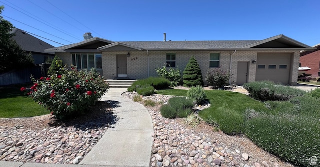 999 N Grand Ave, Provo, UT 84604 - ranch-style home featuring brick siding, a garage, and a shingled roof