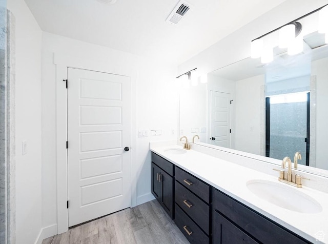 709 E 2450 N, North Logan, UT 84341 - bathroom with wood finished floors, double vanity, baseboards, and a shower