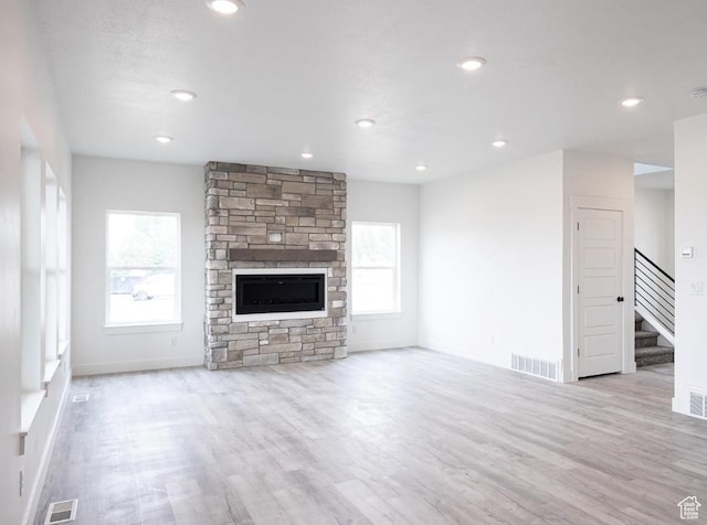 709 E 2450 N, North Logan, UT 84341 - unfurnished living room featuring healthy amount of natural light, stairs, wood finished floors, baseboards, and recessed lighting