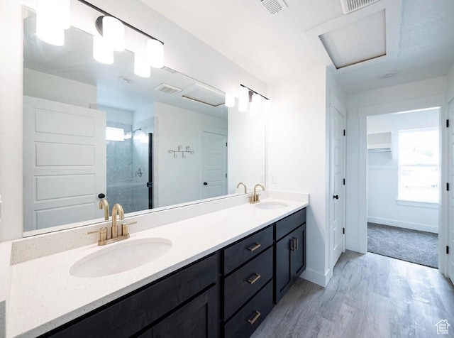 709 E 2450 N, North Logan, UT 84341 - full bathroom with wood finished floors, a stall shower, double vanity, baseboards, and a spacious closet