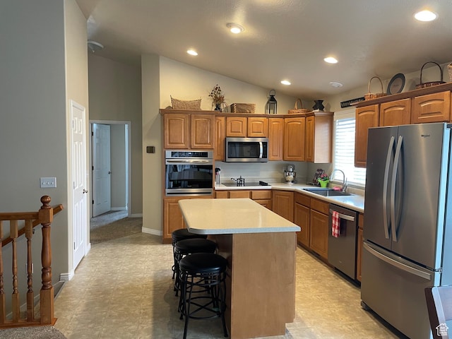 536 E 2200 N, North Ogden, UT 84414 - kitchen featuring appliances with stainless steel finishes, a sink, light countertops, vaulted ceiling, and a center island