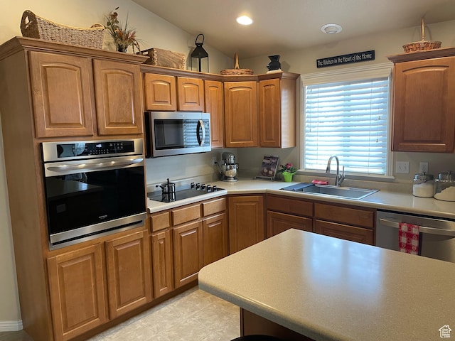 536 E 2200 N, North Ogden, UT 84414 - kitchen with stainless steel appliances, a sink, light countertops, brown cabinetry, and recessed lighting