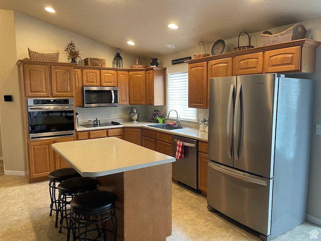 536 E 2200 N, North Ogden, UT 84414 - kitchen featuring stainless steel appliances, a sink, light countertops, a kitchen island, and a kitchen bar