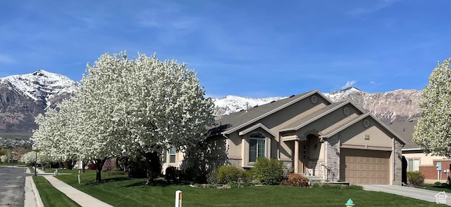 536 E 2200 N, North Ogden, UT 84414 - ranch-style house with a mountain view, a front lawn, driveway, an attached garage, and stucco siding