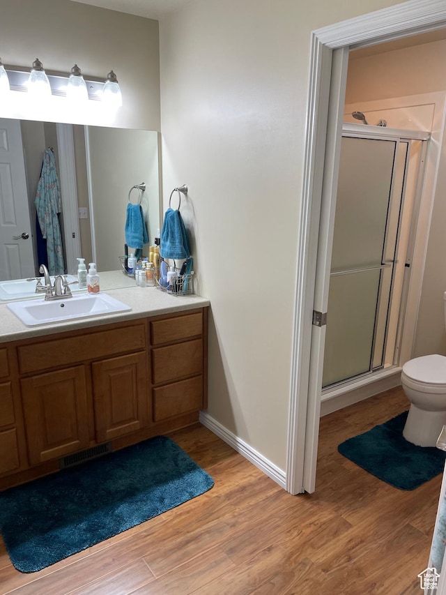536 E 2200 N, North Ogden, UT 84414 - full bathroom featuring wood finished floors, a stall shower, vanity, toilet, and baseboards