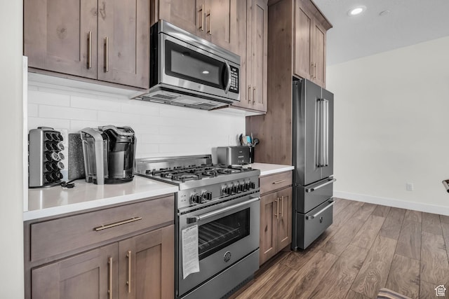 3041 Cedar Dr, Park City, UT 84098 - kitchen with premium appliances, backsplash, dark wood finished floors, baseboards, and light countertops