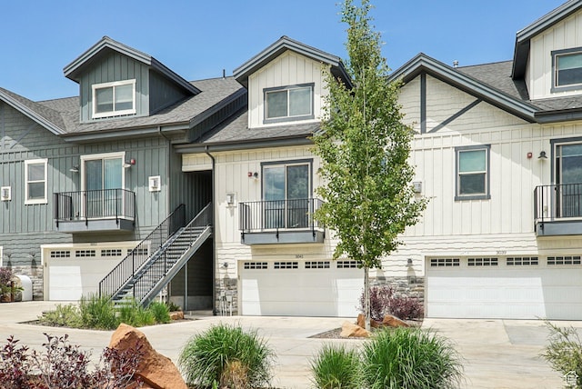 3041 Cedar Dr, Park City, UT 84098 - townhome / multi-family property with driveway, a shingled roof, a garage, and stone siding