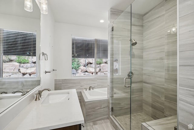 3041 Cedar Dr, Park City, UT 84098 - full bathroom with vanity, a bath, a stall shower, healthy amount of natural light, and recessed lighting
