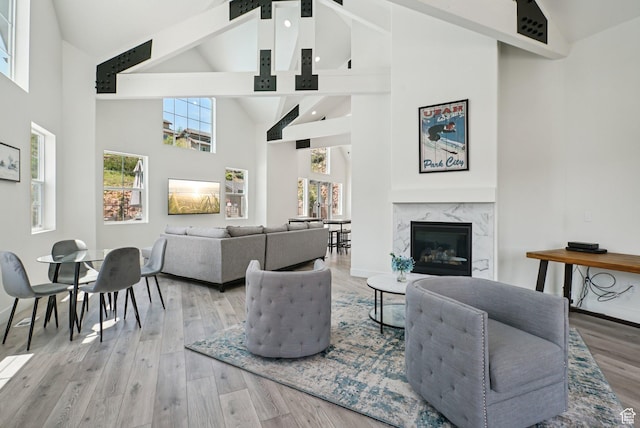 3041 Cedar Dr, Park City, UT 84098 - living room featuring high vaulted ceiling, beamed ceiling, light wood-type flooring, and a fireplace