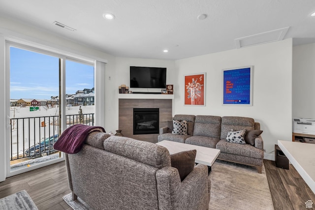 3041 Cedar Dr, Park City, UT 84098 - living room with wood finished floors, a tiled fireplace, and recessed lighting