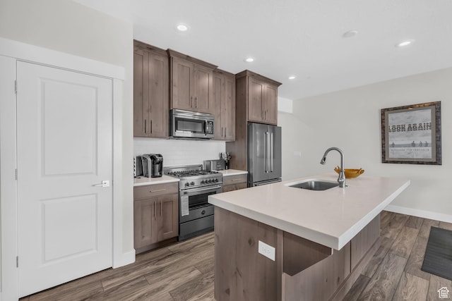 3041 Cedar Dr, Park City, UT 84098 - kitchen featuring high end appliances, a sink, a kitchen island with sink, dark wood-style flooring, and tasteful backsplash