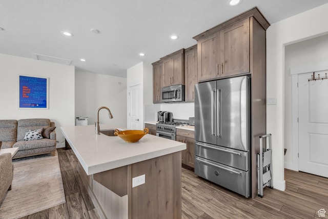 3041 Cedar Dr, Park City, UT 84098 - kitchen with premium appliances, a sink, a center island with sink, open floor plan, and recessed lighting