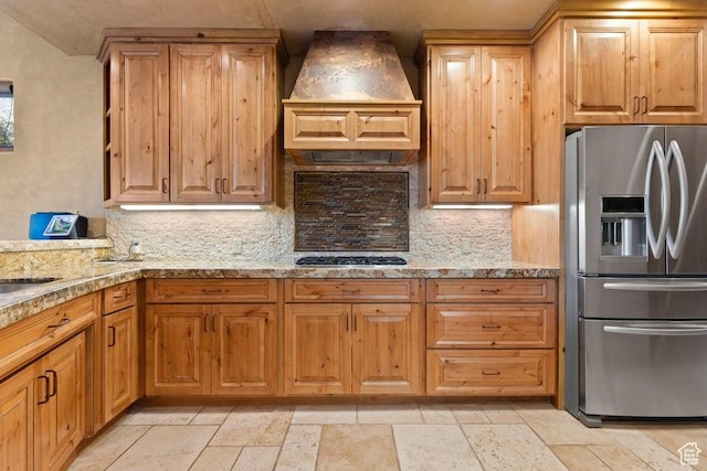2405 W Entrada Trl Unit 76, St George, UT 84770 - kitchen featuring appliances with stainless steel finishes, custom exhaust hood, decorative backsplash, and stone tile flooring