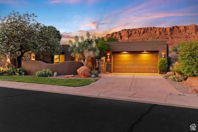 2405 W Entrada Trl Unit 76, St George, UT 84770 - view of front of home with concrete driveway, a garage, and a mountain view