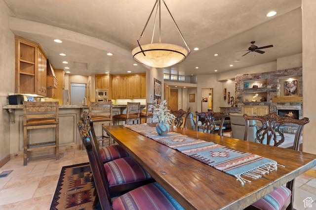 2405 W Entrada Trl Unit 76, St George, UT 84770 - dining space featuring recessed lighting, a ceiling fan, a fireplace, and baseboards