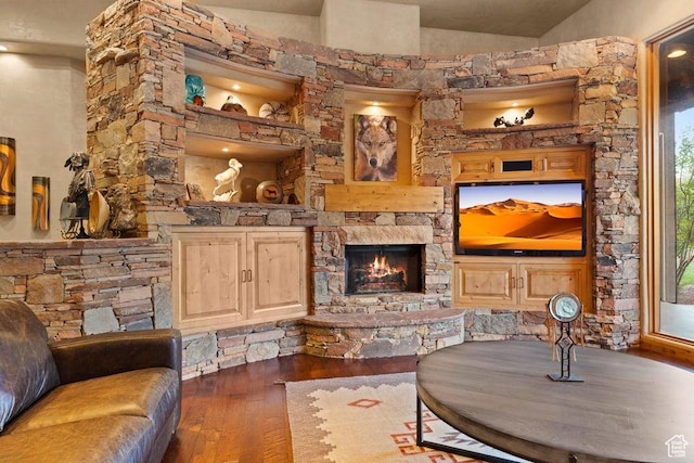 2405 W Entrada Trl Unit 76, St George, UT 84770 - living room featuring wood-type flooring, a stone fireplace, and vaulted ceiling