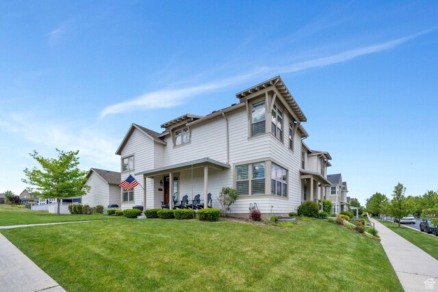 10394 S Crow Wing Dr, South Jordan, UT 84009 - view of front of house featuring a front lawn and covered porch