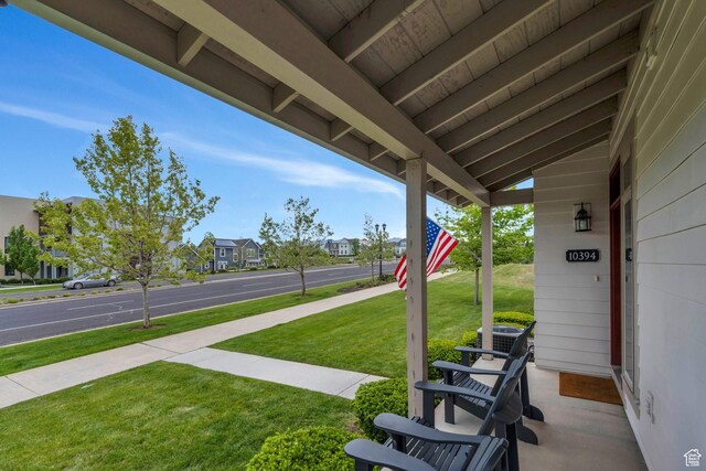 10394 S Crow Wing Dr, South Jordan, UT 84009 - view of grassy yard featuring covered porch, central air condition unit, and a residential view