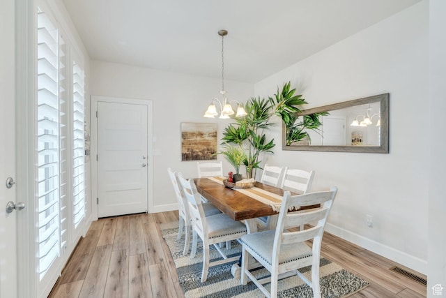10394 S Crow Wing Dr, South Jordan, UT 84009 - dining space featuring plenty of natural light, a chandelier, light wood finished floors, and baseboards