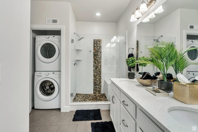 10394 S Crow Wing Dr, South Jordan, UT 84009 - bathroom featuring estacked washer and dryer, a stall shower, tile patterned floors, and double vanity