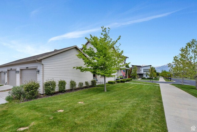 10394 S Crow Wing Dr, South Jordan, UT 84009 - view of property exterior featuring a yard, an attached garage, and a mountain view