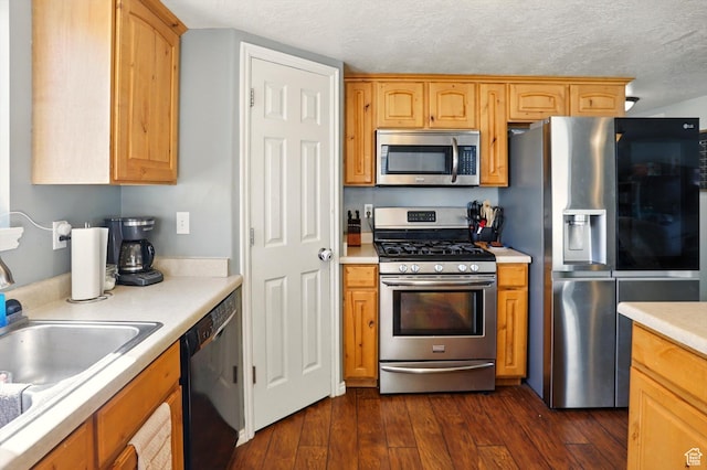 679 S Trail Cir W, Logan, UT 84341 - kitchen featuring appliances with stainless steel finishes, light countertops, dark wood-style flooring, a textured ceiling, and a sink