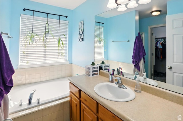 679 S Trail Cir W, Logan, UT 84341 - full bath featuring vanity, a bath, and a walk in closet