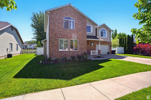 679 S Trail Cir W, Logan, UT 84341 - traditional home featuring a garage, concrete driveway, brick siding, and central AC unit
