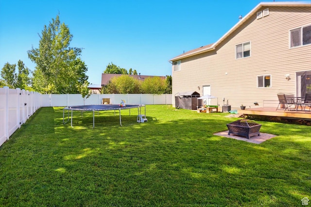 679 S Trail Cir W, Logan, UT 84341 - view of yard with an outdoor fire pit, a deck, and a trampoline