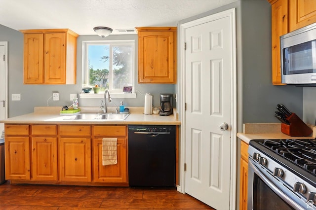 679 S Trail Cir W, Logan, UT 84341 - kitchen featuring appliances with stainless steel finishes, a sink, light countertops, and dark wood-style floors