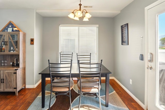 679 S Trail Cir W, Logan, UT 84341 - dining space featuring dark wood-style flooring, a chandelier, baseboards, and plenty of natural light