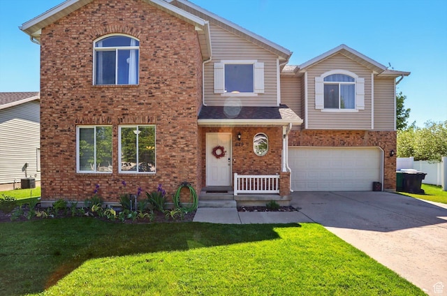 679 S Trail Cir W, Logan, UT 84341 - view of front facade featuring brick siding, a front lawn, concrete driveway, and a garage