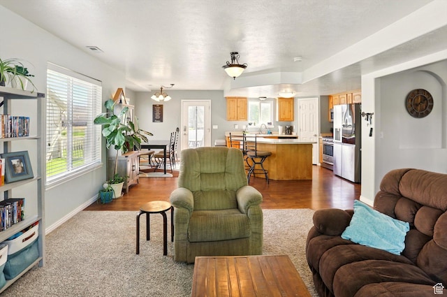 679 S Trail Cir W, Logan, UT 84341 - living area featuring healthy amount of natural light, baseboards, and dark wood-style flooring